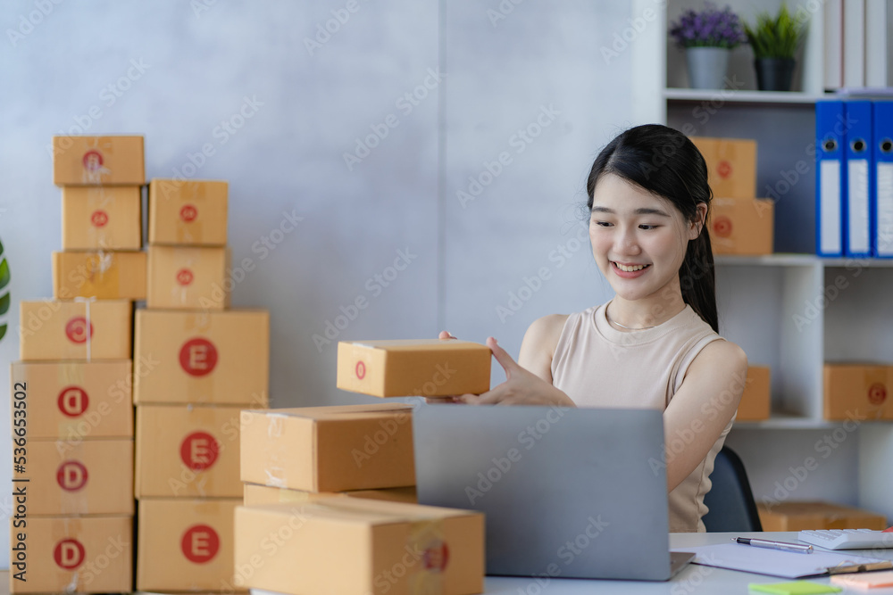 sme business idea cute asian woman selling online at home with laptop to take orders and to deliver yellow parcel boxes online delivery ideas sme business idea cute asian woman selling online at home with laptop to take orders and to deliver yellow parcel boxes online delivery ideas