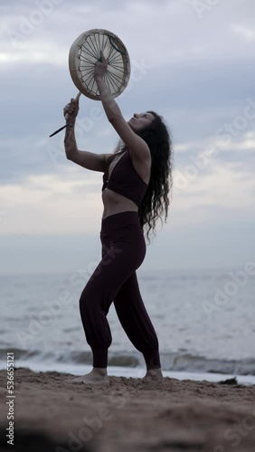 Spiritual Energy Healing on the beach Medicine Woman dancing girl and chanting with a drum 4k slow motion cinematic
