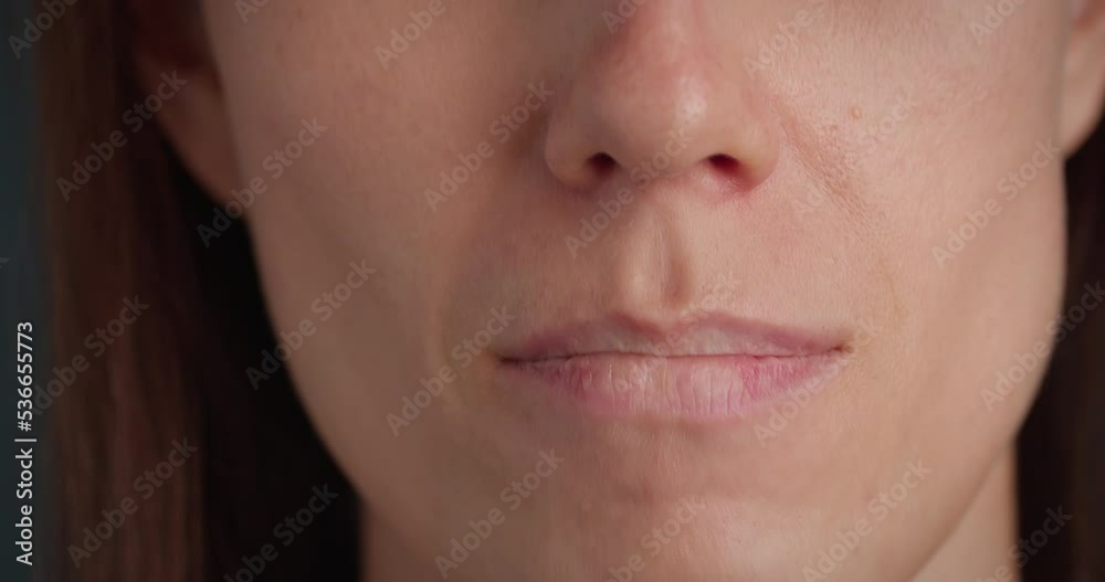 Woman mouth is on lock, sign language zips mouth with hands asks to keep secret, close-up
