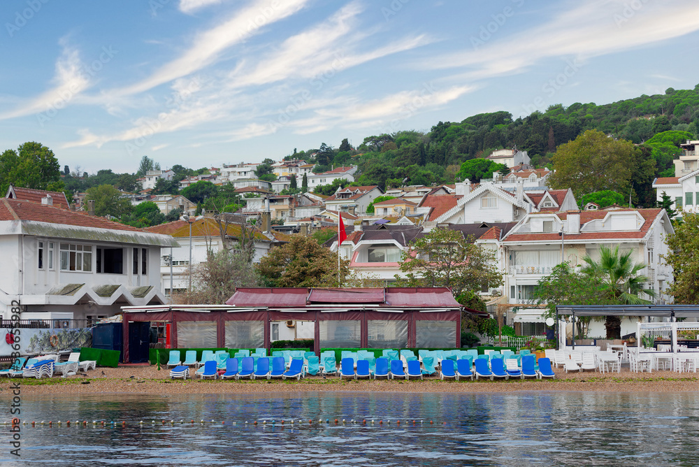View from Marmara sea in the early morning of swimming beach at Kinaliada island with background of green mountains, and traditional summer houses, Istanbul, Turkey View from Marmara sea in the early morning of swimming beach at Kinaliada island with background of green mountains, and traditional summer houses, Istanbul, Turkey