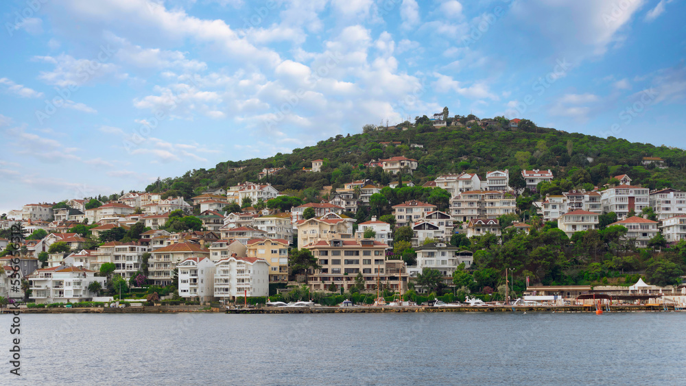 View of the mountains of Kinaliada island from Marmara Sea, with traditional summer houses and boats, Istanbul, Turkey