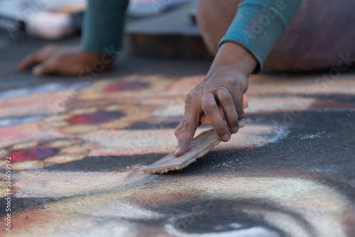 Artist drawing at a chalk art festival