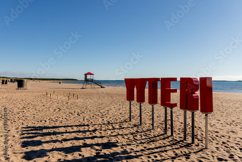 Fototapeta Naklejka Na Ścianę i Meble -  Yyteri Beach and sand dunes on the shore of Baltic Sea in Pori, Finland with red Yyteri sign on the foreground