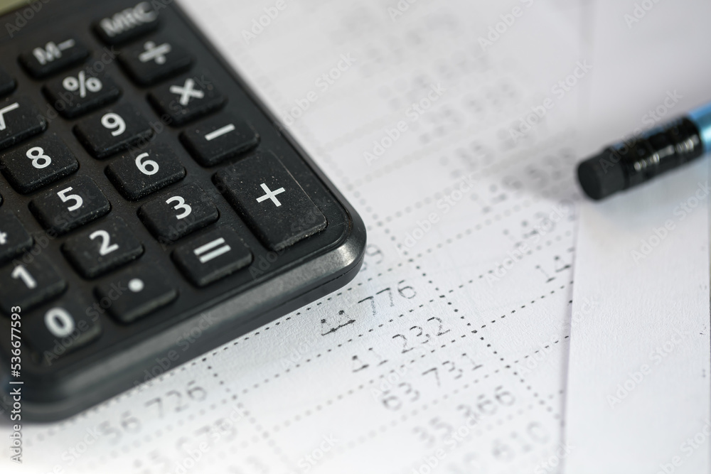Calculator and pencil close-up on a blurred background. Calculator and pencil close-up on a blurred background.