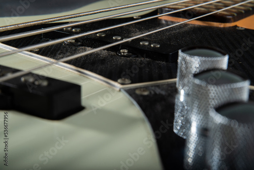 Close up guitar bass string details , four iron strings, white and black color