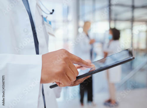 Man hands of hospital doctor with tablet to search through digital medicine clinic medical records, files or documents. Professional healthcare worker, employee or surgeon doing information research