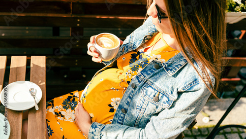 Pregnant woman coffee drink. Lifestyle morning with happy pregnancy girl drink espresso coffee. Represent breakfast, energy, freshness or great aroma concept.