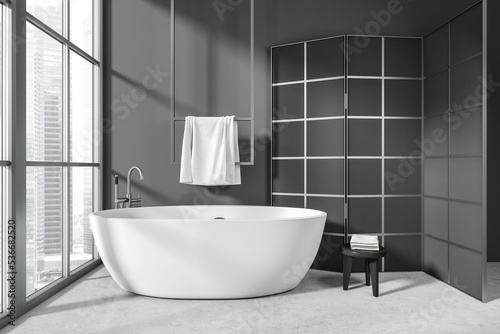 Grey bathroom interior with tub and partition  accessories and panoramic window