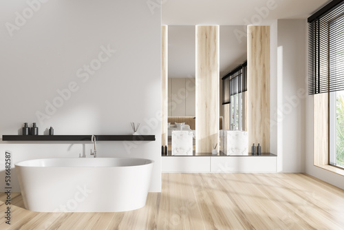 Light hotel studio interior with tub  sink and panoramic window. Mockup wall