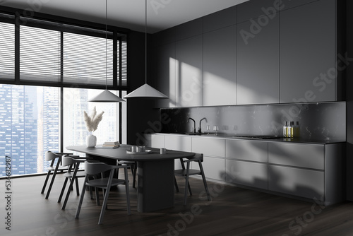 Grey kitchen interior with dining table and chairs  panoramic window