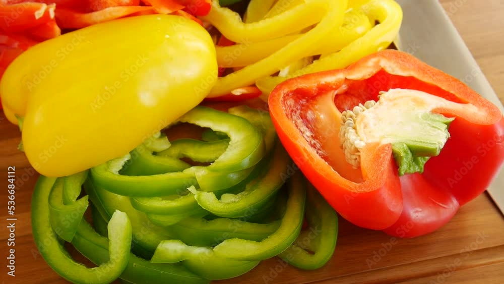 Sliced multi-colored peppers on the board. Sliced multi-colored peppers on the board.