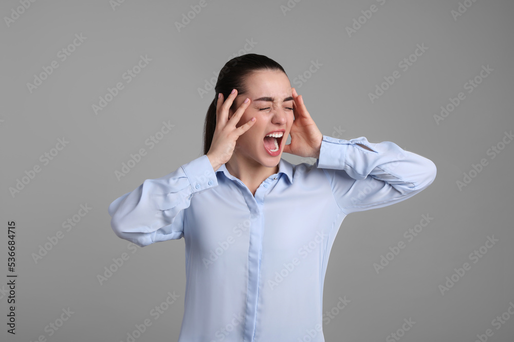 Portrait of emotional young woman on light grey background. Personality concept Portrait of emotional young woman on light grey background. Personality concept