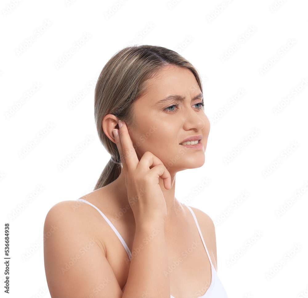 Young woman suffering from ear pain on white background