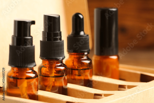 Bottles with oil in box, closeup. Natural cosmetics