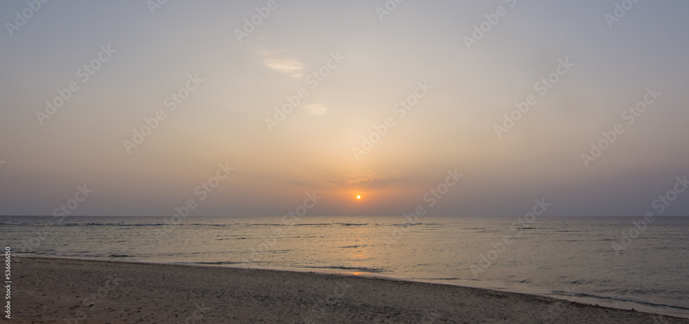 standing at the beach on the sea during sunrise on vacation in egypt panorama