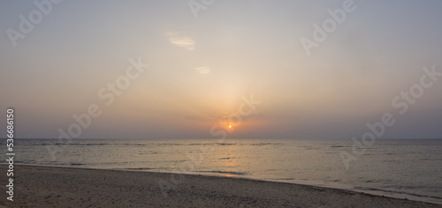standing at the beach on the sea during sunrise on vacation in egypt panorama