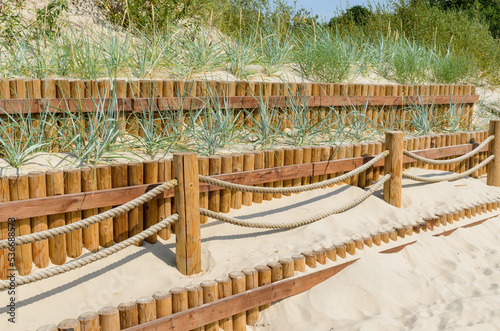 Fence near walking path for reinforcement of dunes