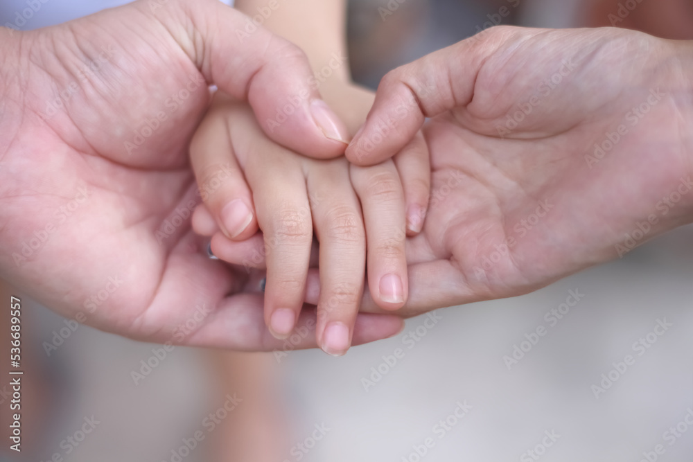 Asian child girl hand with father and mother hand holding daughther for familly bonding love background close up Asian child girl hand with father and mother hand holding daughther for familly bonding love background close up