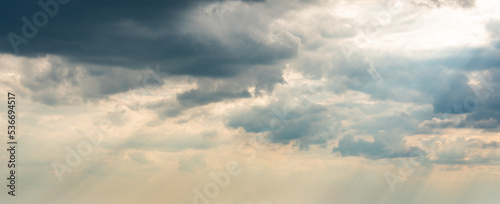 Dramatic Sky Background with sunny beams. Panoramic view of Stormy Clouds in Dark sky © SDF_QWE