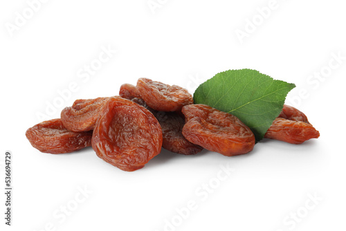 Tasty dried apricots and leaf on white background