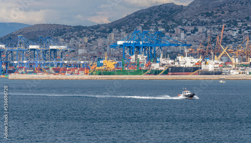 Pilot boat at the port of Piraeus in Greece with shipyards in the background photo