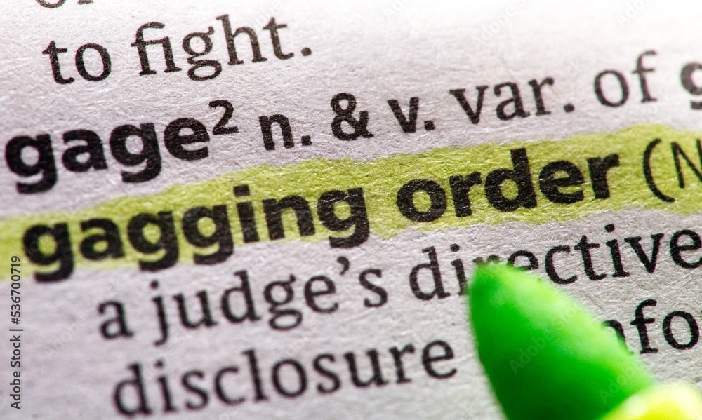 Obraz premium Photo of the words gagging order in a dictionary book