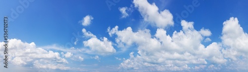 White cumulus clouds on clear blue sky background panorama, beautiful cloudscape wide panoramic view, cloudy skies backdrop, fluffy cloud texture, sunny summer day heaven landscape, cloudiness weather