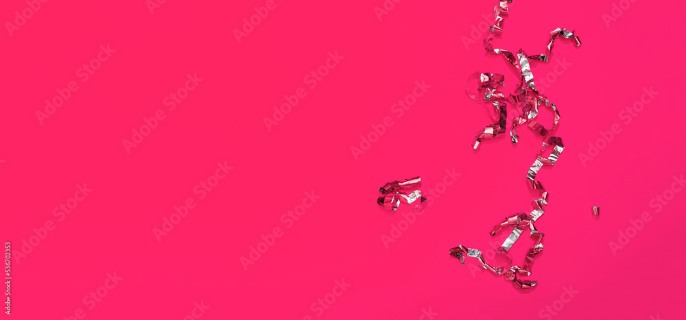 Pink background with bright confetti and serpentines. Festive banner with copy space. Mockup design of greeting card with empty text place. New year, birthday and Christmas holiday templates concept