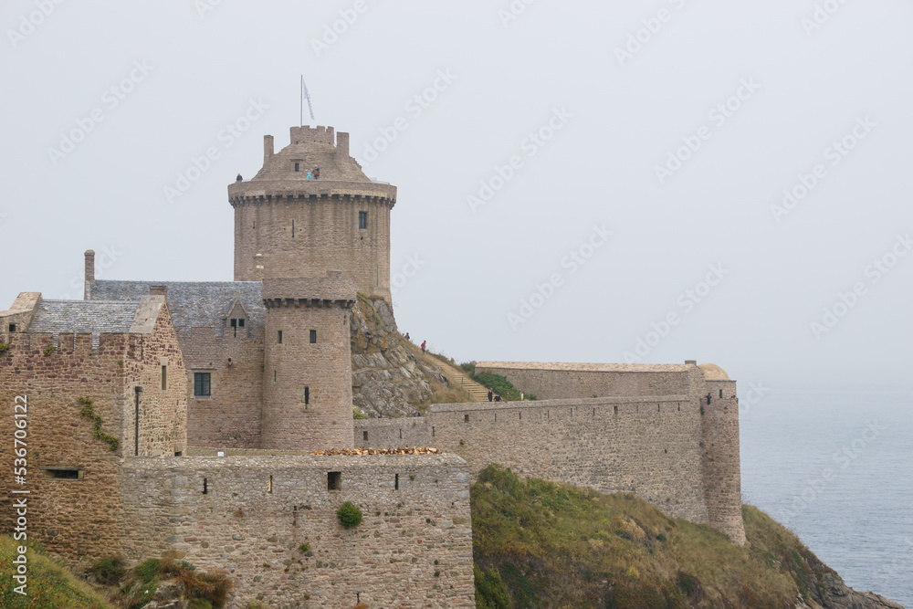 Famous ancient Fort-La-Latte castle on the Cote d'Emeraude, near Cap Frehel on a misty summer day, Bretagne, France