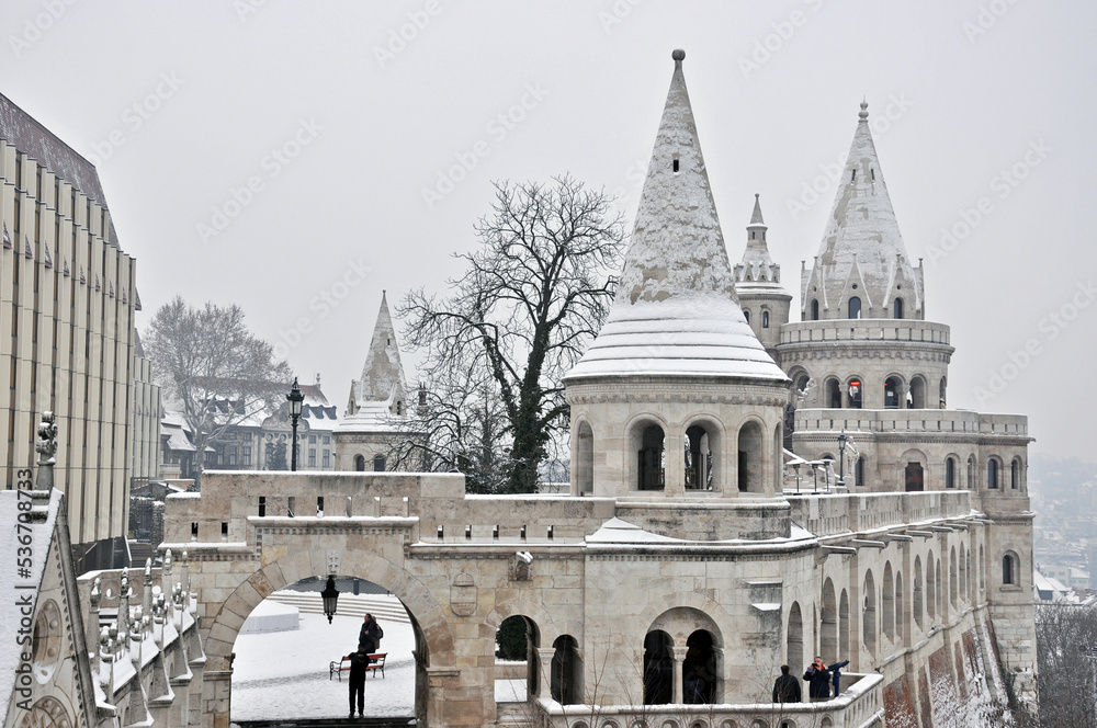 Fisherman`s Bastion in Budapest, Hungary, in a cold snowy and foggy winter day
