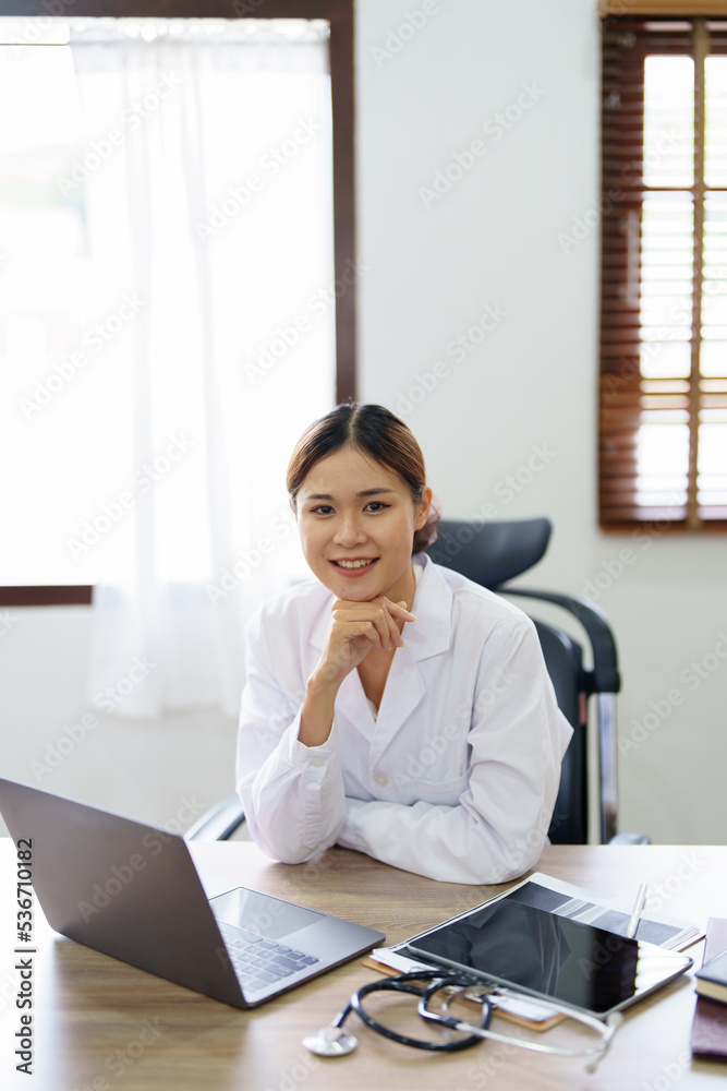 Portrait of an Asian doctor using a computer Portrait of an Asian doctor using a computer