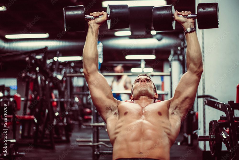 Fototapeta premium Man working out with dumbbells