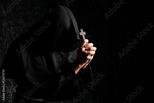 Fotografie, Obraz A monk praying with a rosary and crucifix in his hand.