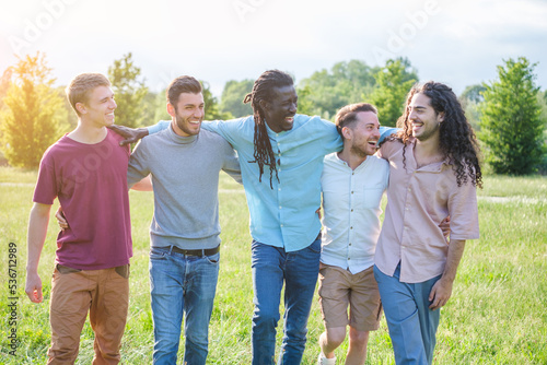 Group of boys of different nationalities hanging out together in the park enjoying good weather