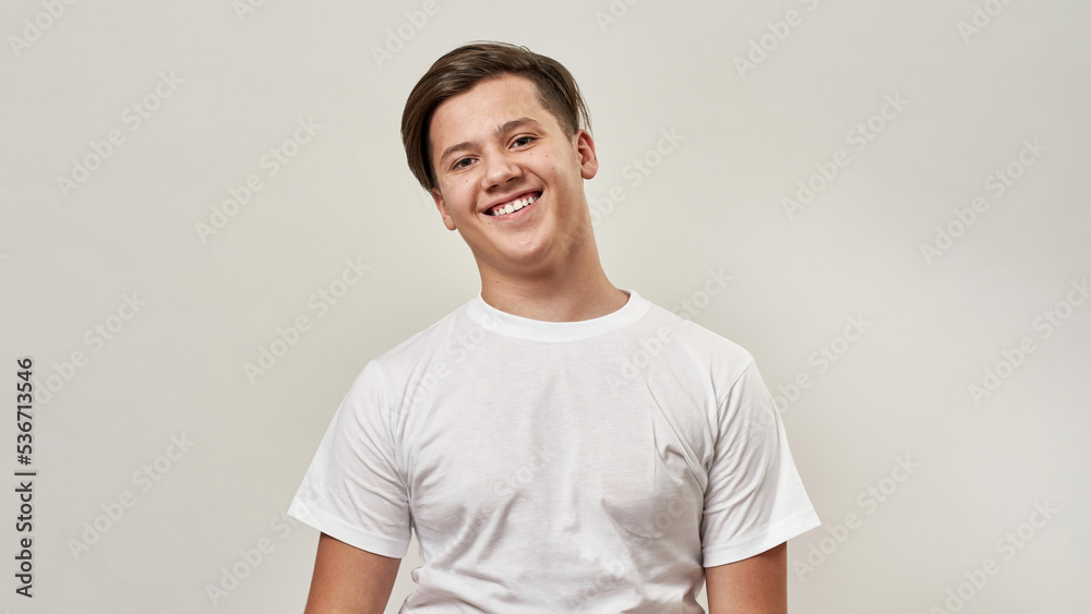 Partial of smiling teenage boy looking at camera