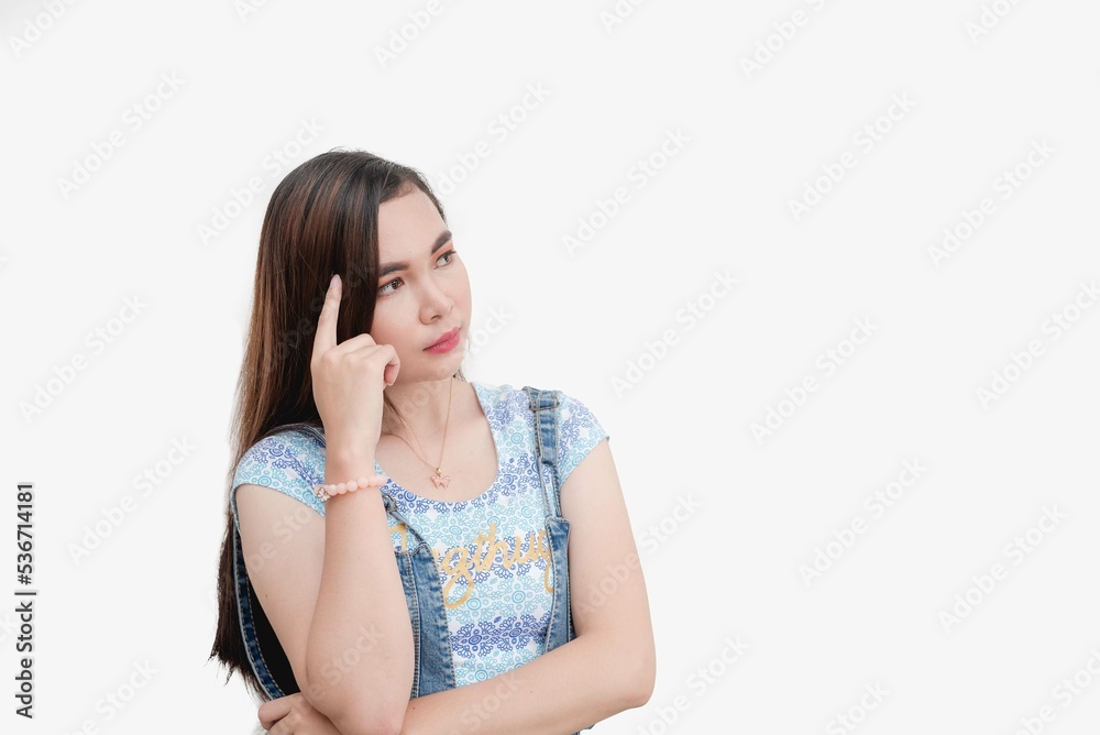 An Asian woman points at her temple as she makes a gesture that implies thinking. A girl contemplating about her obligations at home. An Asian woman points at her temple as she makes a gesture that implies thinking. A girl contemplating about her obligations at home.