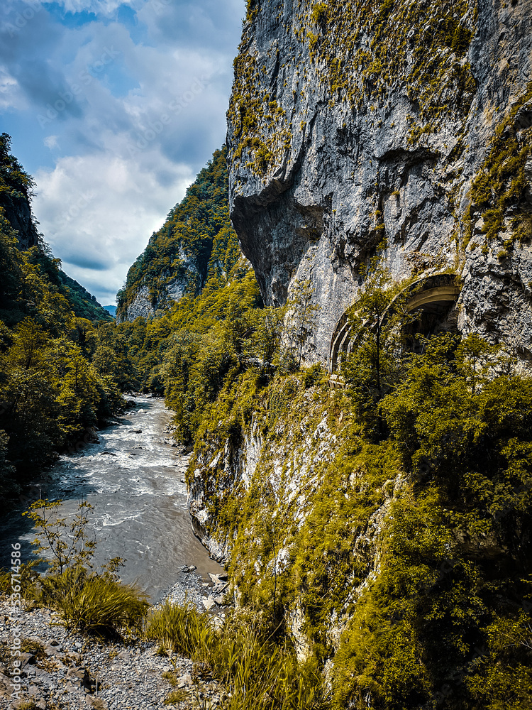 Autumn view of the Mzymta River and the old road on Krasnaya Polyana (Sochi, Russia)