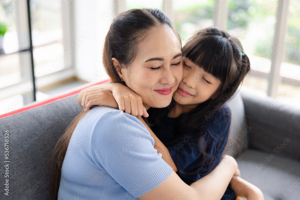 Closeup attractive lovely smile mother and little daughter girl eye close embrace and enjoy family love moment Closeup attractive lovely smile mother and little daughter girl eye close embrace and enjoy family love moment