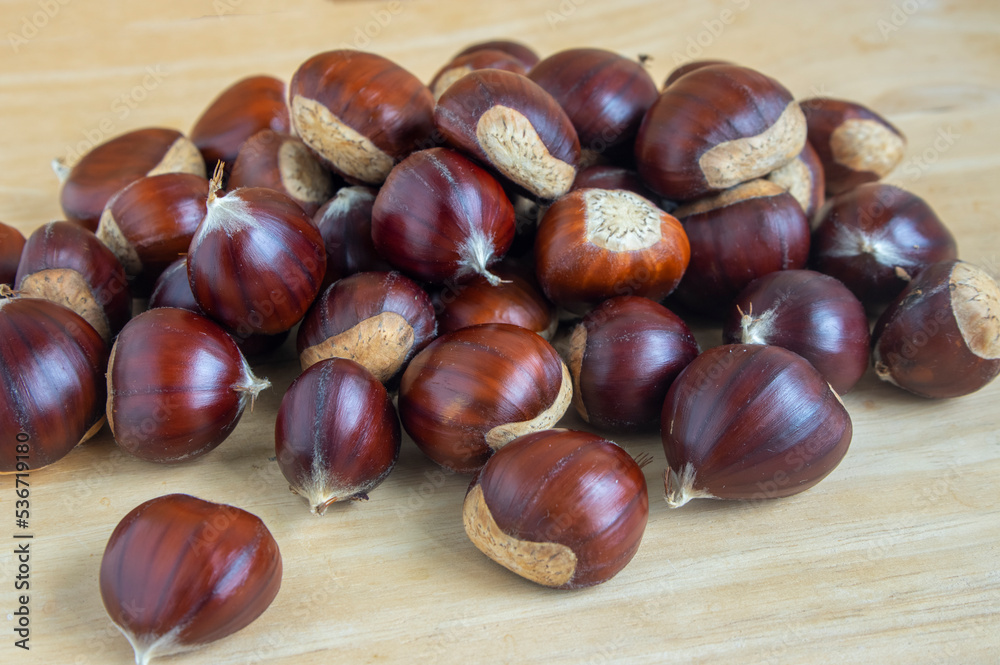 Fresh castanea sativa fruits on the table, sweet chestnuts ready for cooking, tasty brownish nuts marrons Fresh castanea sativa fruits on the table, sweet chestnuts ready for cooking, tasty brownish nuts marrons
