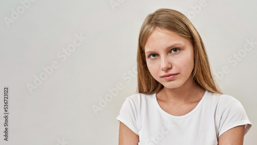 Partial of serious teenage girl looking at camera