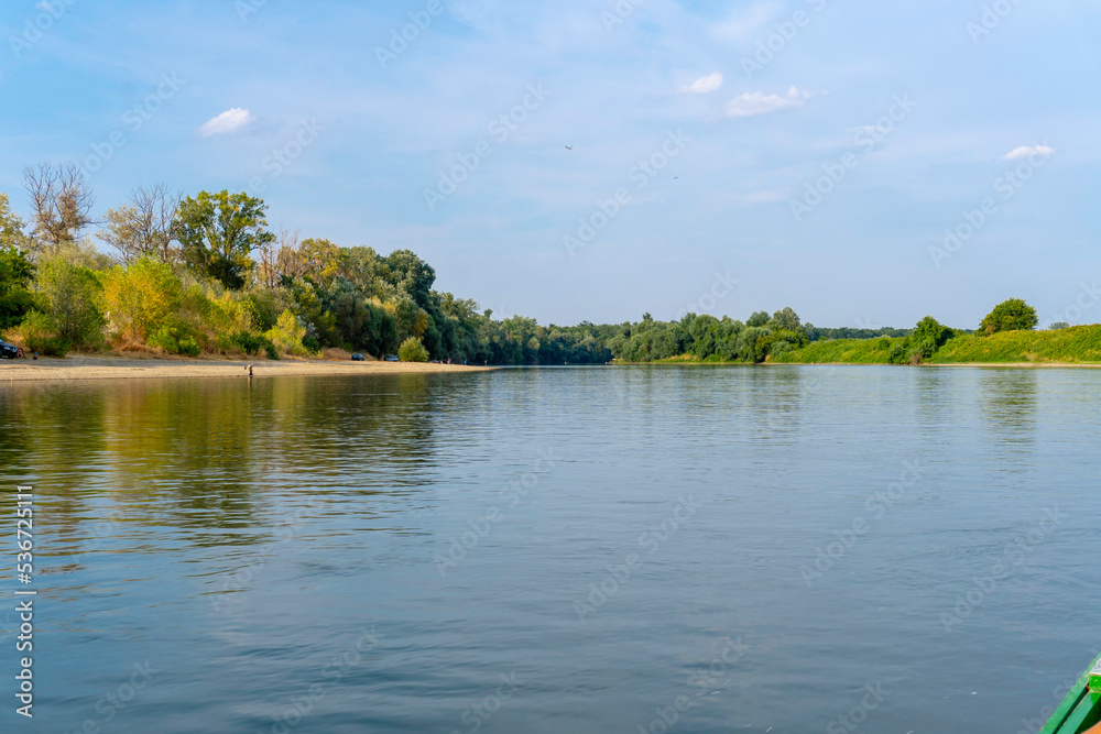 Fototapeta premium Sunny day on a calm river in summer