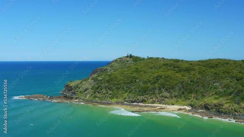 Beautiful Green Headland Surrounded By Turquoise Ocean Waves And Beach, 4K Aerial Drone