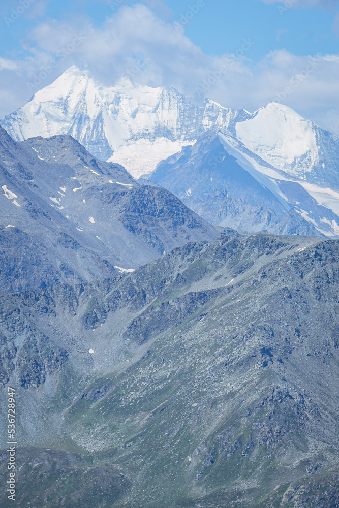 Obraz premium The landscape of the Swiss Alps, with the highest peaks and glaciers of the canton of Valais viewed from the Simplon Pass, Switzerland - July 2022.