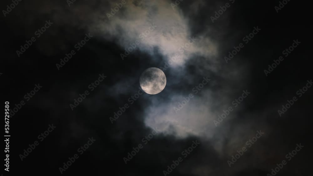 Dramatic clouds passing Moon in dark night sky. Footage in real time, 4K resolution. Dramatic clouds passing Moon in dark night sky. Footage in real time, 4K resolution.