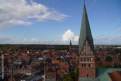 Historic center with a lot of red brick gabled houses, tile red roofs and the St. Johannis Church in the Hanseatic city of Lüneburg, Lower Saxony, Germany, Europe.