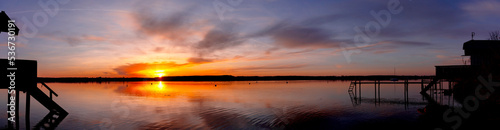 Panorama of beautiful colorful sunset with houses in the front at Ammersee Bavaria Germany