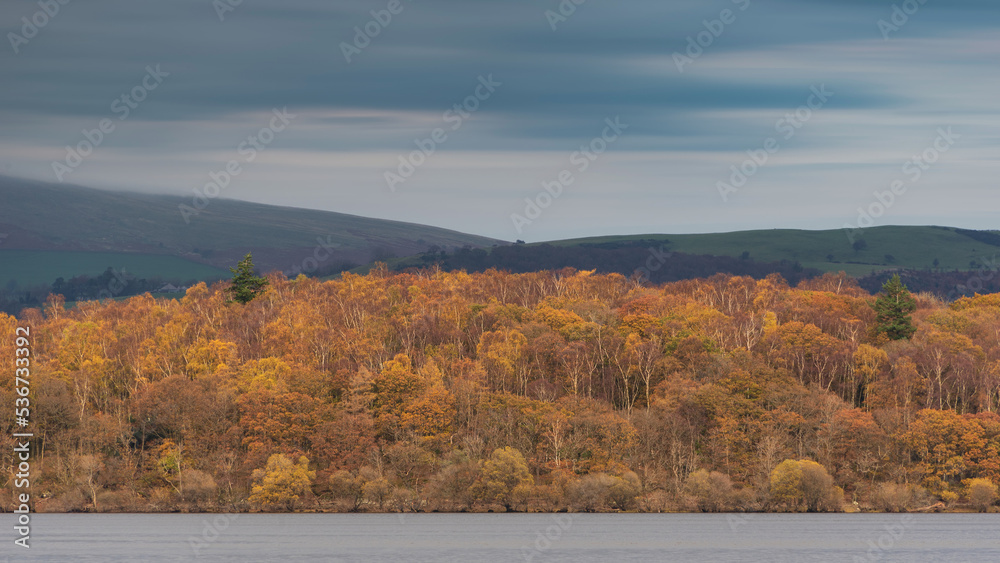 Stunning landscape image across Bassenthwaite Lake in Lake District suring moody stormy Autumn evening Stunning landscape image across Bassenthwaite Lake in Lake District suring moody stormy Autumn evening