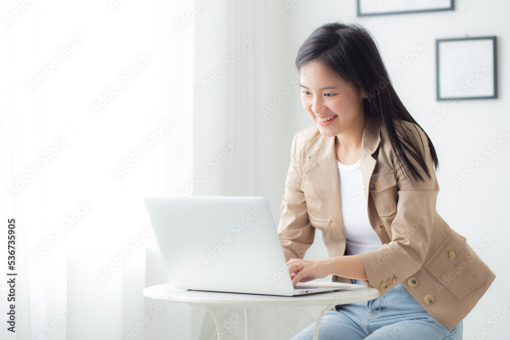 Young asian businesswoman working on laptop computer on desk at home office, freelance looking and typing on notebook on table, lifestyles of woman studying online, business and education concept. Young asian businesswoman working on laptop computer on desk at home office, freelance looking and typing on notebook on table, lifestyles of woman studying online, business and education concept.