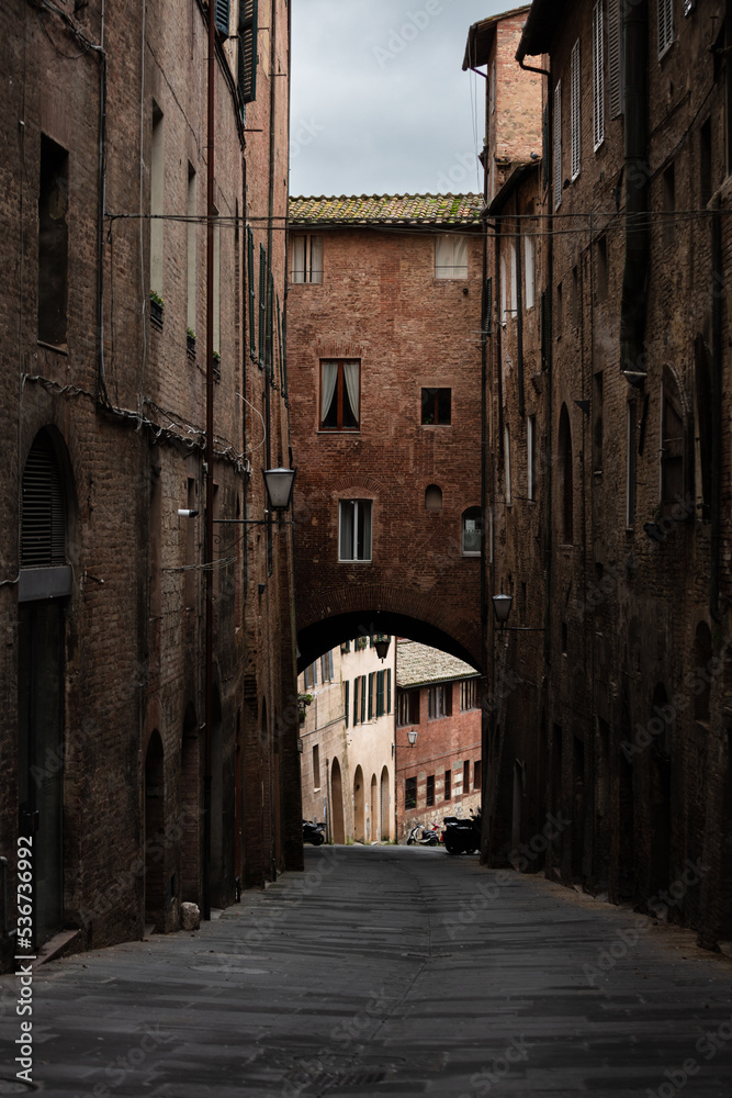 narrow street in Siena, Tuscany