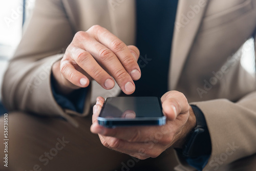 Businessman use mobile phone, click on screen